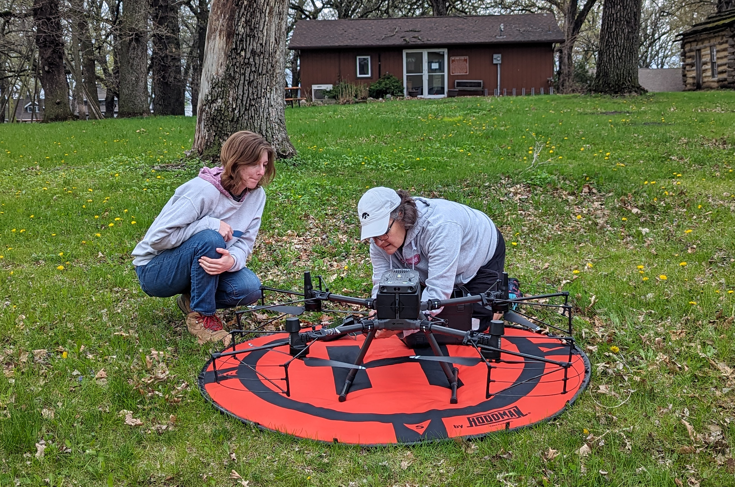 Two women setting up a drone