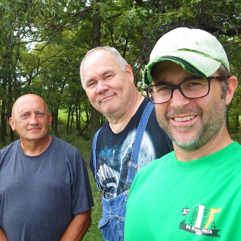 Three men smiling during a selfie