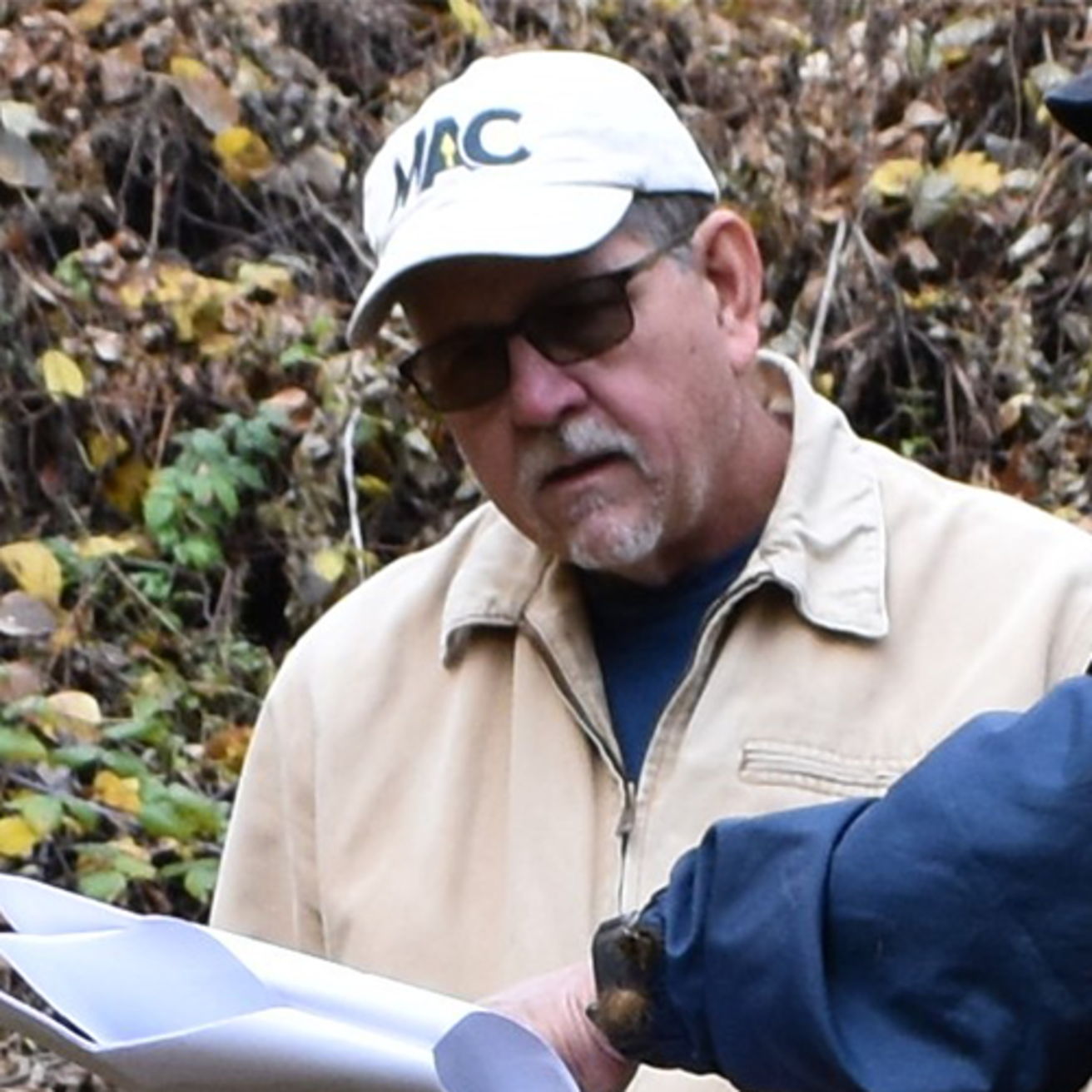 A man in a hat and sunglasses