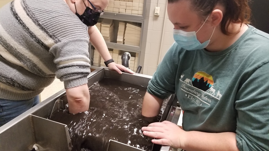 Two women work at a soil flotation machine