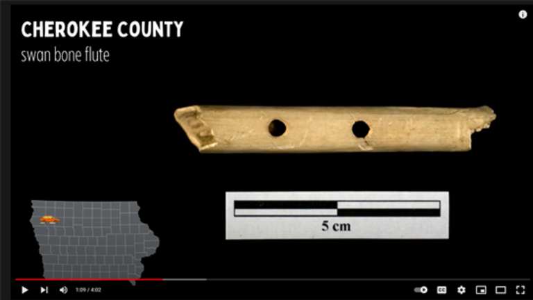 A screenshot of a YouTube video showing a bone flute